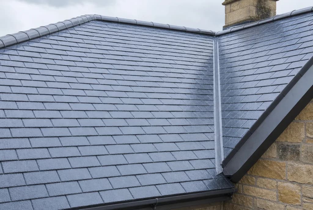 Close-up of a newly laid natural slate roof with lead ridge